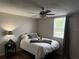 Cozy bedroom featuring a ceiling fan and wood floors at 14400 Saint Georges Hill Dr, Orlando, FL 32828
