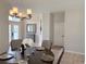 Dining room features a chandelier, a dark wood table with chairs, and views of the home's entry area at 14400 Saint Georges Hill Dr, Orlando, FL 32828