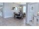 A dining area featuring an elegant chandelier and furniture set is adjacent to the living space at 14400 Saint Georges Hill Dr, Orlando, FL 32828