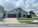 Charming two-story home with landscaped yard and attached two-car garage at 14400 Saint Georges Hill Dr, Orlando, FL 32828