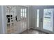 Bright foyer featuring decorative glass doors leading to an office space with tiled floors and neutral walls at 14400 Saint Georges Hill Dr, Orlando, FL 32828
