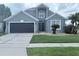 Charming two-story home featuring a well-manicured lawn and a two-car garage at 14400 Saint Georges Hill Dr, Orlando, FL 32828