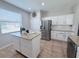 Well-lit kitchen features granite countertops, white cabinets, and stainless steel appliances at 14400 Saint Georges Hill Dr, Orlando, FL 32828