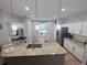 Bright kitchen with granite counters, stainless appliances, white cabinets, and an island with bar stool seating at 14400 Saint Georges Hill Dr, Orlando, FL 32828