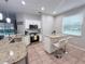 Charming kitchen features granite countertops, stainless steel appliances, and a cozy breakfast bar with seating at 14400 Saint Georges Hill Dr, Orlando, FL 32828