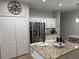 Spacious kitchen featuring stainless steel refrigerator and granite countertops at 14400 Saint Georges Hill Dr, Orlando, FL 32828