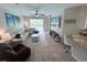 An open living area that features a large sofa, a view of the outdoor swimming pool, and tiled floors at 14400 Saint Georges Hill Dr, Orlando, FL 32828