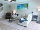 Cozy living room features a sectional sofa, decorative art, and tiled flooring, perfect for relaxation and entertainment at 14400 Saint Georges Hill Dr, Orlando, FL 32828