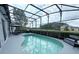 Inviting in-ground pool with a screened enclosure, perfect for relaxation and outdoor enjoyment at 14400 Saint Georges Hill Dr, Orlando, FL 32828