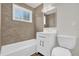 This bathroom features tiled walls, a shower-tub combo, a vanity, and a toilet at 1491 Granada Ave, Daytona Beach, FL 32117