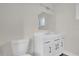 Bathroom featuring a white vanity, modern mirror, and a toilet at 1491 Granada Ave, Daytona Beach, FL 32117