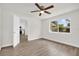 Clean bedroom with wood-look flooring, window, and a view to the kitchen at 1491 Granada Ave, Daytona Beach, FL 32117