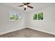 Bright bedroom featuring two large windows, wood-look flooring, and natural light at 1491 Granada Ave, Daytona Beach, FL 32117