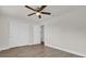 Bedroom with closet, ceiling fan, wood-look flooring and a view to another room at 1491 Granada Ave, Daytona Beach, FL 32117