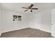 Bright, spacious bedroom featuring a ceiling fan, window, and wood-look flooring at 1491 Granada Ave, Daytona Beach, FL 32117
