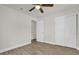 This bedroom features wood-look floors, a ceiling fan, and a double-door closet at 1491 Granada Ave, Daytona Beach, FL 32117
