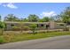 A quaint single-story home with a well-manicured front lawn and traditional design at 1491 Granada Ave, Daytona Beach, FL 32117