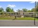 Charming single-story home with a stone accent wall and a well-maintained lawn at 1491 Granada Ave, Daytona Beach, FL 32117