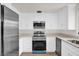 Bright kitchen with stainless steel appliances, white cabinets, and modern countertops at 1491 Granada Ave, Daytona Beach, FL 32117