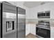Contemporary kitchen featuring stainless steel appliances and sleek white cabinets at 1491 Granada Ave, Daytona Beach, FL 32117