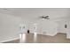 Bright living room with new laminate flooring and ceiling fan at 1491 Granada Ave, Daytona Beach, FL 32117