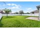 Well-maintained backyard featuring lush green grass and a pristine white fence providing privacy at 1553 Caterpillar St, St Cloud, FL 34771