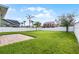 Large grassy backyard enclosed by a white fence, providing a secure and private outdoor space at 1553 Caterpillar St, St Cloud, FL 34771