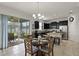 Sunlit dining area adjacent to a modern kitchen with backyard views at 1553 Caterpillar St, St Cloud, FL 34771