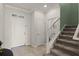Inviting foyer with tile flooring, staircase, and ample natural light at 1553 Caterpillar St, St Cloud, FL 34771