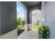 A peaceful front porch with natural stone tiles and decorative foliage at 1553 Caterpillar St, St Cloud, FL 34771
