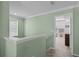 Bright hallway leading to a bedroom, showcasing fresh, green paint and carpeted flooring at 1553 Caterpillar St, St Cloud, FL 34771