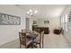 Open-concept living room featuring a chandelier, tile floors, and comfortable seating area with plenty of natural light at 1553 Caterpillar St, St Cloud, FL 34771