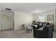 Cozy living room with neutral walls, carpet flooring, and plenty of natural light at 1553 Caterpillar St, St Cloud, FL 34771