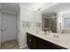 Bathroom featuring a double vanity with plenty of storage and large mirror, shower, and linen closet at 1553 Caterpillar St, St Cloud, FL 34771