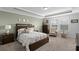 Inviting main bedroom with tray ceilings, carpet flooring, a large bed, and plenty of natural light at 1553 Caterpillar St, St Cloud, FL 34771