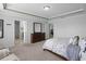 Open main bedroom with tray ceiling, carpet flooring, and a view into the Primary bathroom at 1553 Caterpillar St, St Cloud, FL 34771