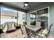 Screened patio features a ceiling fan and an outdoor dining table for al fresco enjoyment at 1553 Caterpillar St, St Cloud, FL 34771