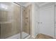 Beautiful tiled shower with a glass door enclosure in the main bathroom at 1553 Caterpillar St, St Cloud, FL 34771