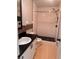 Updated bathroom with white vanity, black countertop, and a shower with glass door at 1603 Emily Ct, Kissimmee, FL 34744