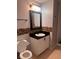 Bathroom featuring a white sink vanity with black countertop, mosaic tile backsplash, toilet and shower at 1603 Emily Ct, Kissimmee, FL 34744
