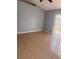 Spacious bedroom featuring tile flooring, light gray walls, and a sliding glass door to a patio at 1603 Emily Ct, Kissimmee, FL 34744