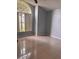 Bright bedroom featuring tile flooring, a large arched window, and neutral gray walls at 1603 Emily Ct, Kissimmee, FL 34744