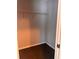 A walk-in closet with a single shelf and dark brown carpet at 1603 Emily Ct, Kissimmee, FL 34744