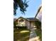 Charming single-story home featuring a well-manicured lawn and a walkway leading to the front door at 1603 Emily Ct, Kissimmee, FL 34744