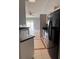 Modern kitchen features black countertops and stainless steel appliances at 1603 Emily Ct, Kissimmee, FL 34744