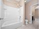 Clean bathroom with a bathtub and shower combination and tiled floors at 1610 Mohegan Blvd, Kissimmee, FL 34744