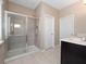 Bathroom showcasing glass-enclosed shower with tile surround and modern fixtures at 1610 Mohegan Blvd, Kissimmee, FL 34744