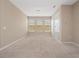 Spacious bedroom with three windows letting in natural light and plush carpeting at 1610 Mohegan Blvd, Kissimmee, FL 34744
