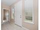 Bright foyer with tile flooring, white trim, and natural light streaming through the windows at 1610 Mohegan Blvd, Kissimmee, FL 34744