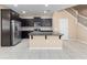 Kitchen features dark cabinets, stainless steel appliances, and a center island with granite countertop at 1610 Mohegan Blvd, Kissimmee, FL 34744